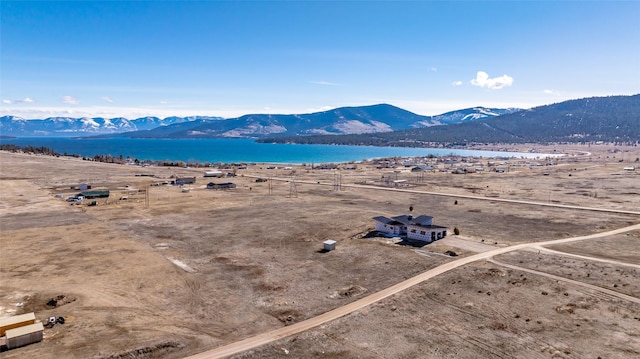 drone / aerial view featuring a water and mountain view