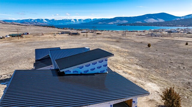 birds eye view of property featuring a water and mountain view