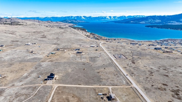 birds eye view of property featuring a water and mountain view