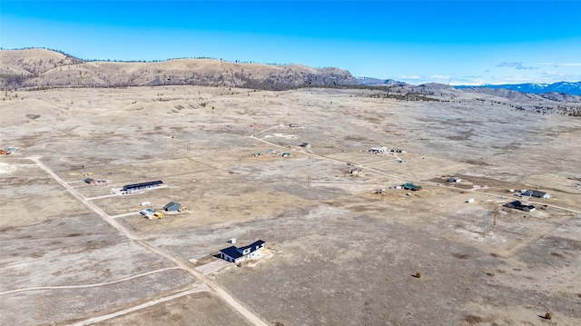 birds eye view of property featuring a mountain view and a desert view