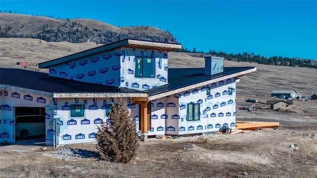 25978 Caye Dr, Elmo, MT 59915 - property in mid-construction with a mountain view, an attached garage, and a chimney