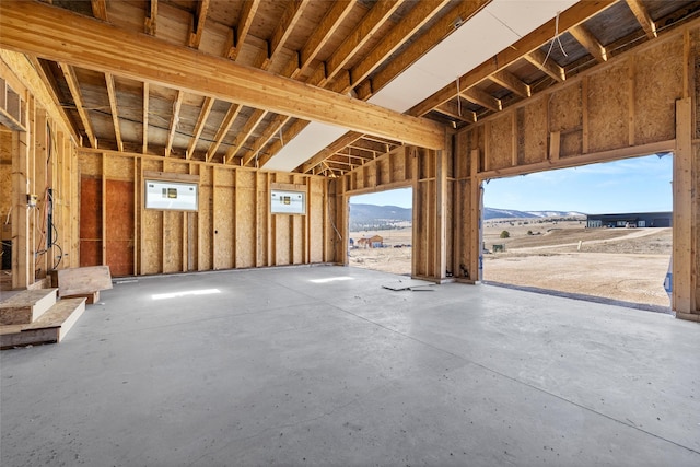 miscellaneous room with a mountain view and concrete flooring