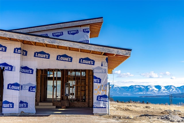 entrance to property with a water and mountain view