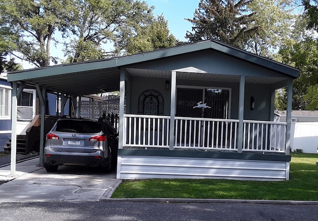 view of front facade featuring a carport, a porch, and concrete driveway