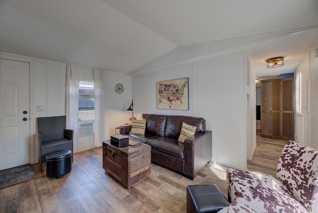 living area featuring wood finished floors and vaulted ceiling