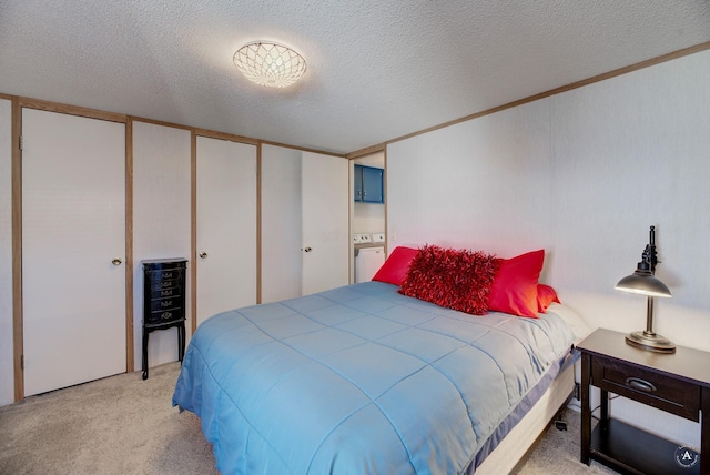 carpeted bedroom with a closet and a textured ceiling