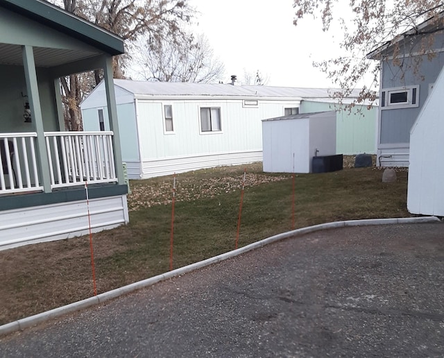 view of home's exterior featuring a lawn and a porch