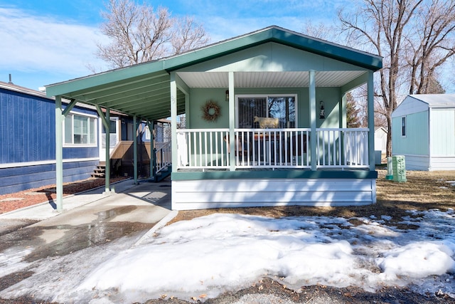 view of front of home featuring a carport and covered porch