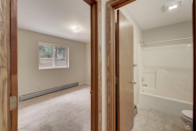 full bath with a baseboard radiator, toilet, washtub / shower combination, and tile patterned flooring