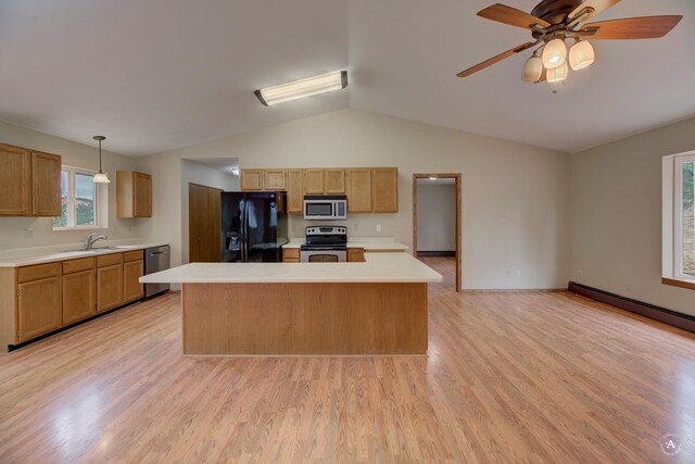 6520 Canyon Ferry Rd, Helena, MT 59602 - kitchen with stainless steel appliances, lofted ceiling, light countertops, light wood-type flooring, and a center island