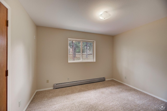 empty room featuring baseboards, carpet floors, and baseboard heating