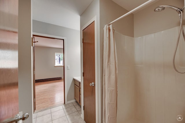 bathroom with a shower with shower curtain, baseboards, vanity, and tile patterned flooring