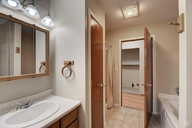 full bath with tile patterned floors, curtained shower, vanity, and a washtub