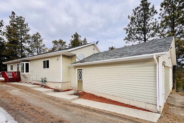 exterior space with a shingled roof