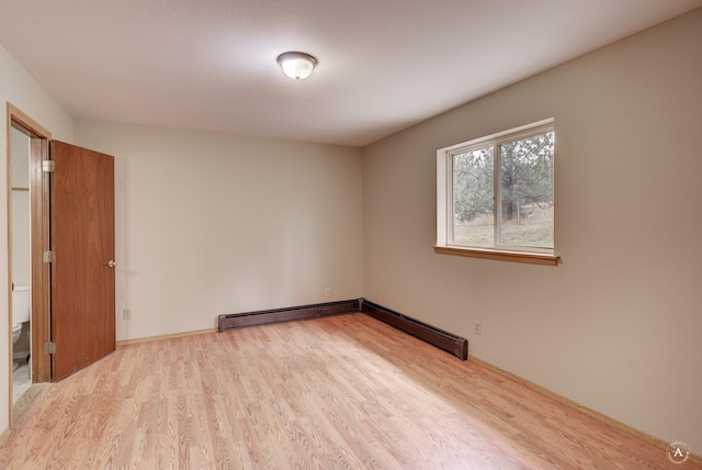 6520 Canyon Ferry Rd, Helena, MT 59602 - spare room with wood finished floors and a baseboard radiator