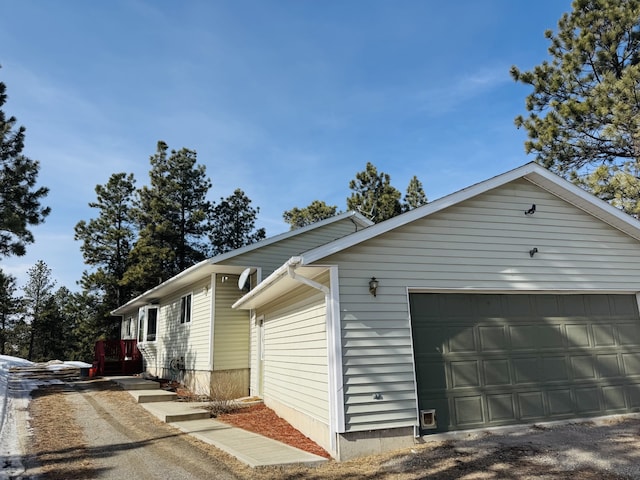 view of side of home featuring a garage