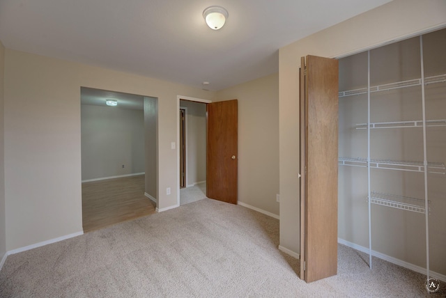 unfurnished bedroom featuring a closet, baseboards, and carpet