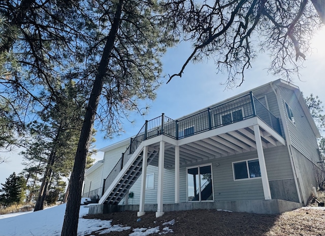 back of property featuring stairs