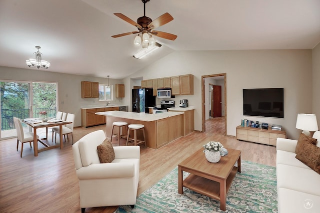 6520 Canyon Ferry Rd, Helena, MT 59602 - living room with light wood finished floors, lofted ceiling, a chandelier, and ceiling fan