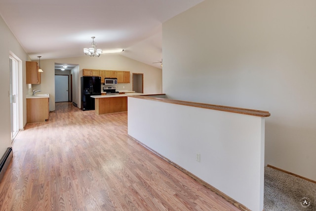 6520 Canyon Ferry Rd, Helena, MT 59602 - kitchen with stainless steel appliances, lofted ceiling, light countertops, a kitchen island, and light wood finished floors