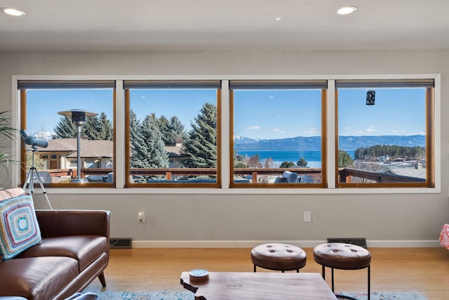 sitting room with visible vents, wood finished floors, recessed lighting, a mountain view, and baseboards