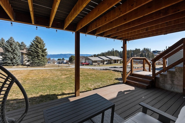 deck featuring a lawn and a mountain view