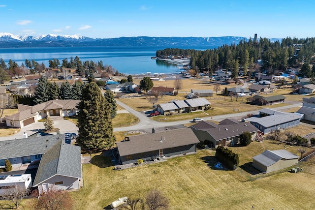 drone / aerial view with a residential view and a water and mountain view