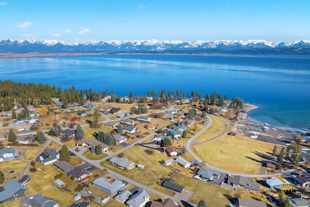 drone / aerial view with a residential view and a water and mountain view