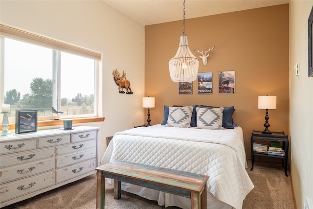 bedroom with a notable chandelier and carpet flooring