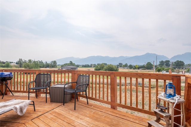 wooden deck featuring grilling area and a mountain view