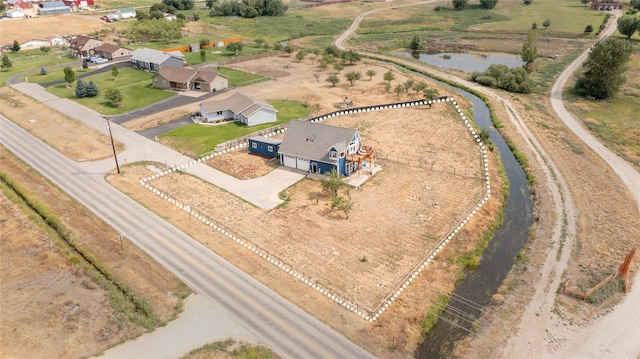 birds eye view of property featuring a rural view and a water view