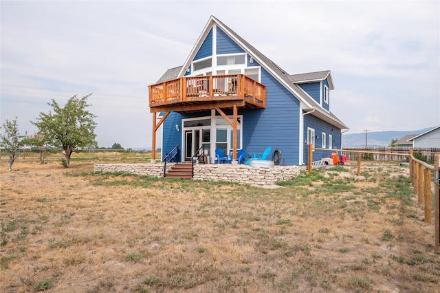 rear view of house featuring fence