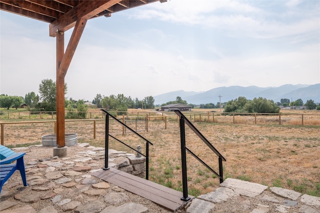 exterior space with a mountain view, a rural view, and fence