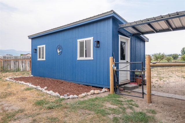 exterior space with fence and metal roof