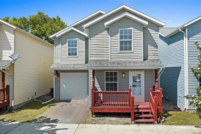 view of front of property featuring driveway, a shingled roof, and a garage