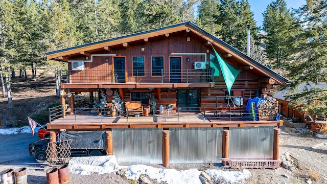 view of front of property with log exterior and a wooden deck