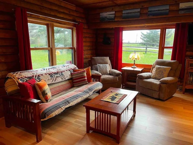 interior space featuring log walls and wood finished floors