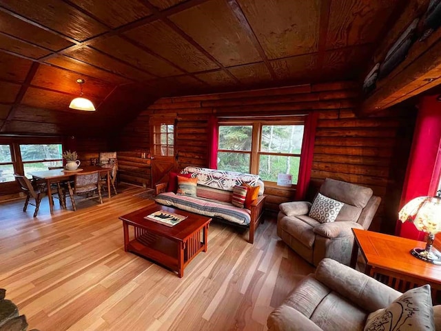 living room featuring wooden ceiling, wood finished floors, and log walls