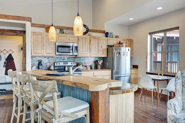 kitchen with decorative backsplash, dark wood-type flooring, light brown cabinets, and appliances with stainless steel finishes