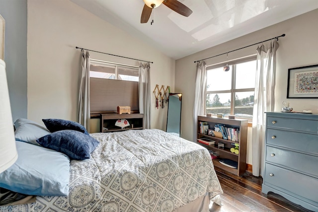 bedroom featuring vaulted ceiling, multiple windows, a ceiling fan, and dark wood-style flooring