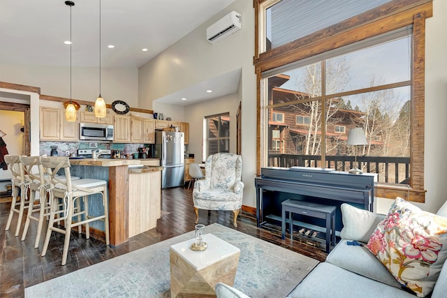 living area featuring dark wood finished floors, a wall unit AC, plenty of natural light, and recessed lighting