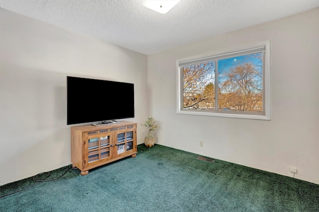 unfurnished living room with visible vents, a textured ceiling, and carpet floors