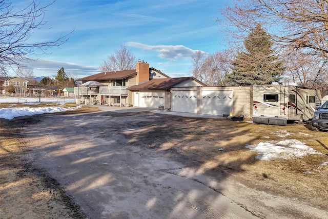 view of front of home with a garage and a chimney