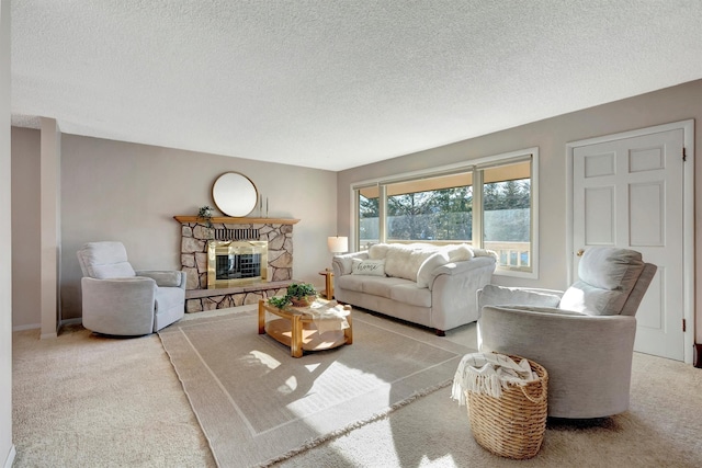 carpeted living area featuring a textured ceiling and a fireplace