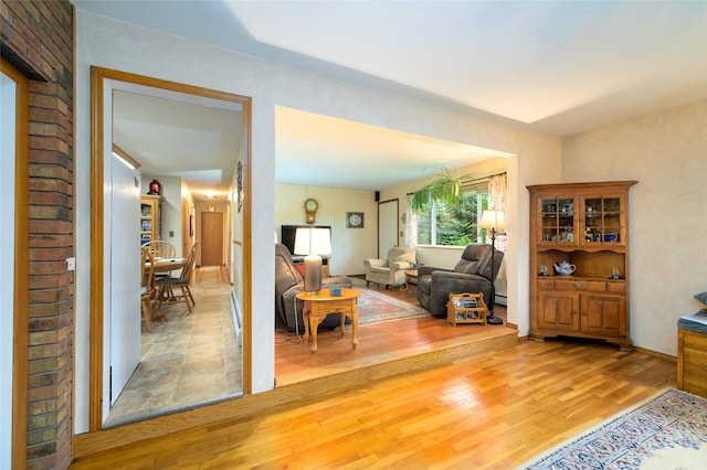 living area with wood finished floors and baseboard heating