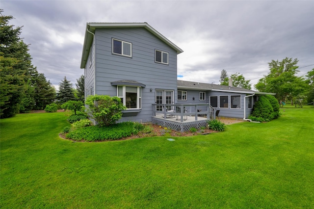 back of house featuring a yard and a wooden deck