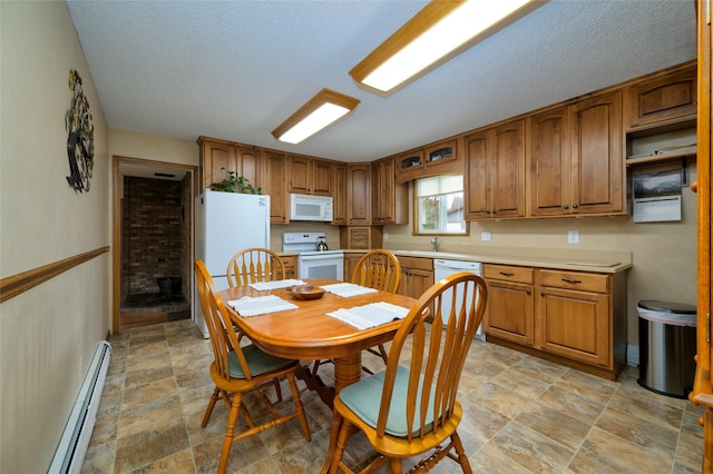 dining area featuring a baseboard heating unit, baseboards, a textured ceiling, and stone finish flooring