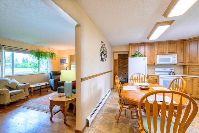 dining room with light wood-type flooring, a textured ceiling, and a baseboard heating unit