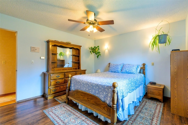 bedroom with a textured ceiling, a ceiling fan, baseboards, and wood finished floors