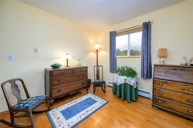 living area featuring a baseboard radiator and light wood-style flooring